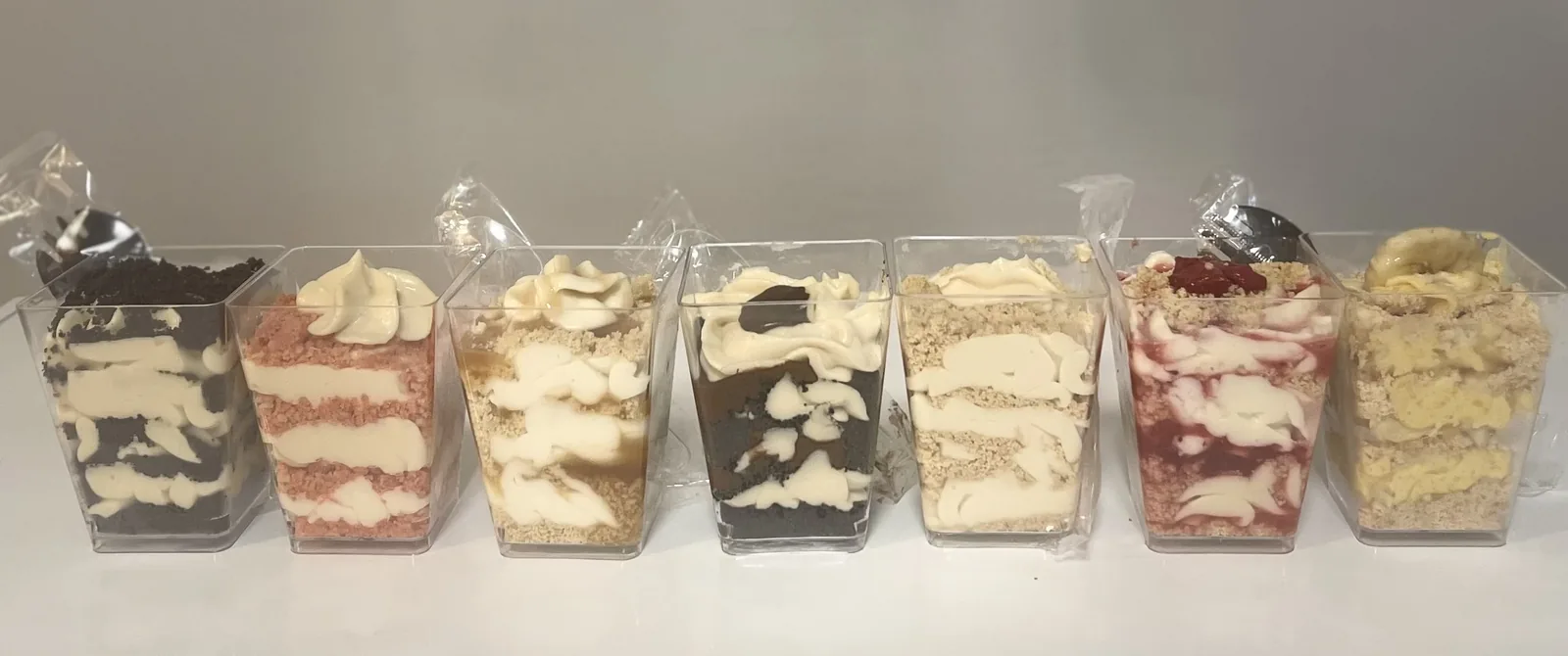Assorted Bowlicious Eats cheesecake cups lined up
